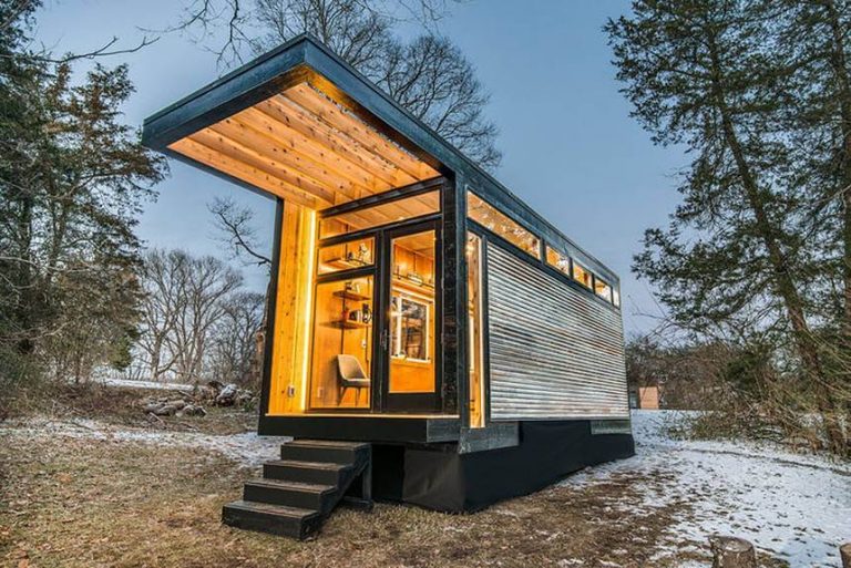going tiny house with lights on in wilderness